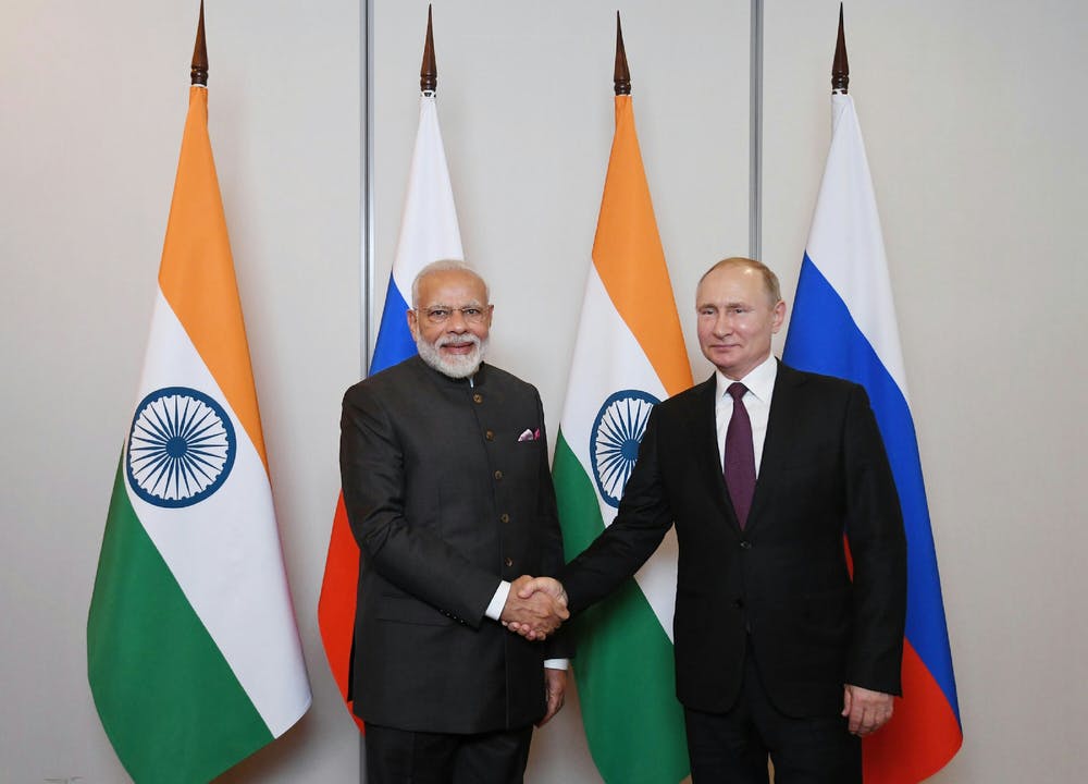 Narendra Modi and Vladimir Putin shaking hands