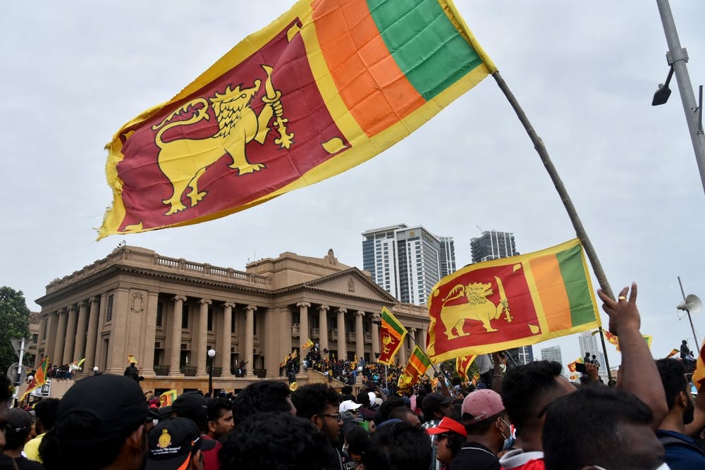 Protesters wave a Sri Lankan flag outside of the presidential secretariat office in Colombo