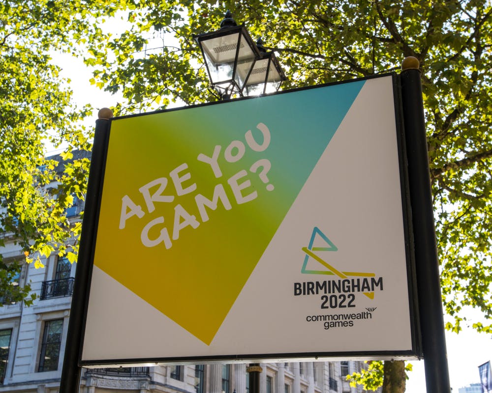 Sign outdoors reading Are You Game? with the Birmingham 2022 Commonwealth Games logo