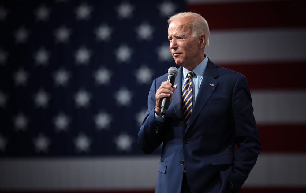 Joe Biden stands in front of an American flag