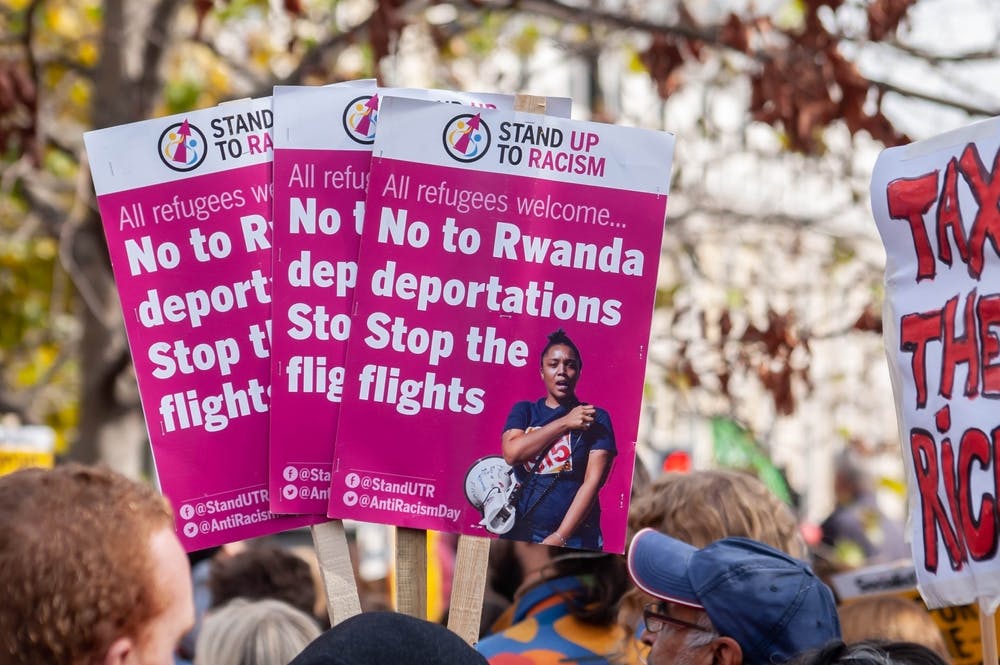 Protesters hold signs reading No to Rwanda deportations