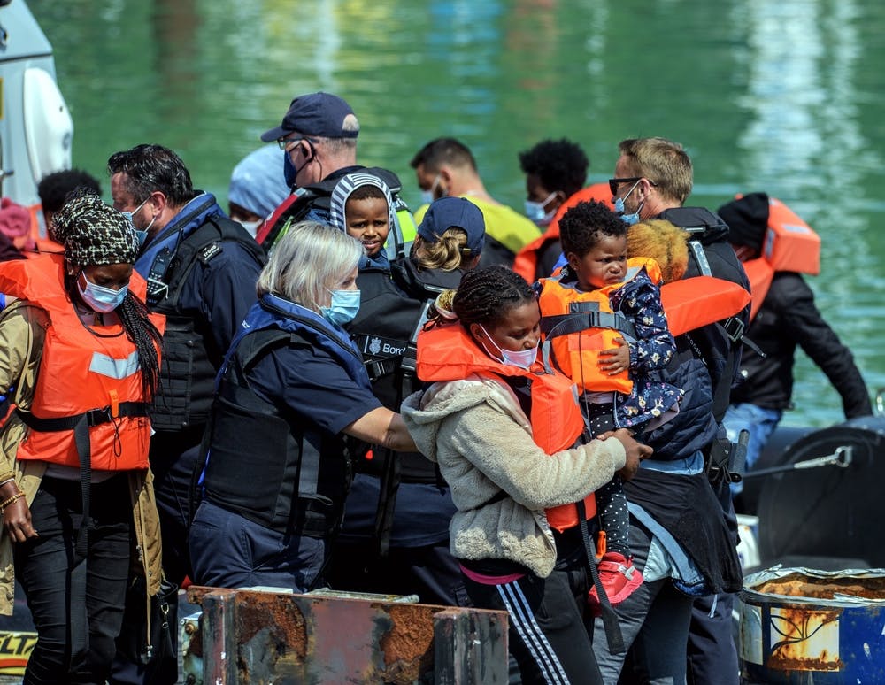 Migrants leave a boat at Dover