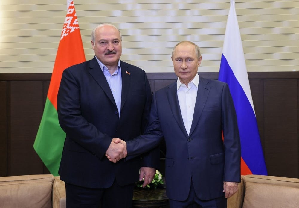 Lukashenko shaking Putin's hand