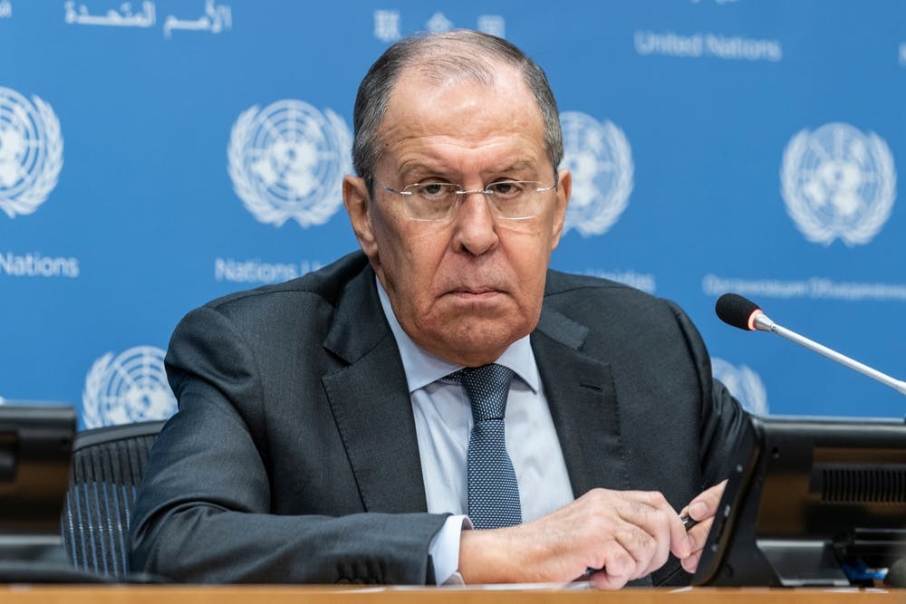 Sergey Lavrov sits at a table with UN logos in the background