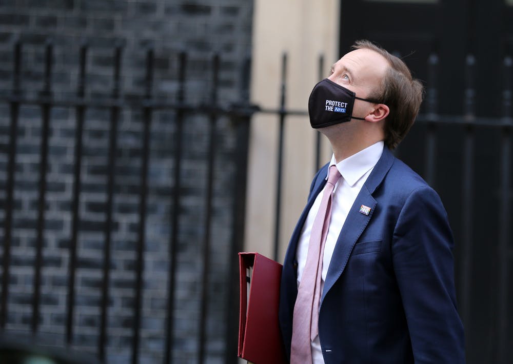Matt Hancock walks in front of Downing Street wearing a facemask