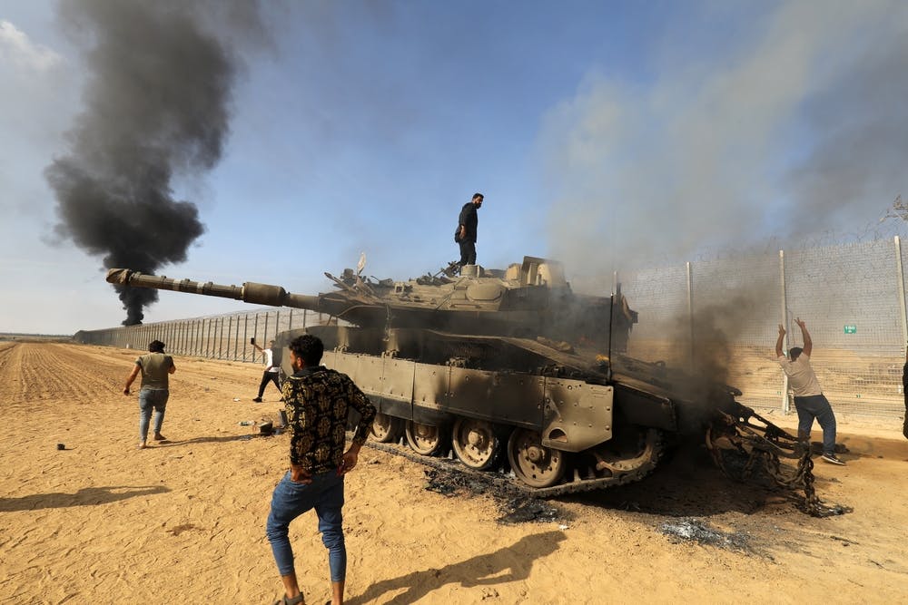 Palestinians use a tank to storm the Israeli border on October 7