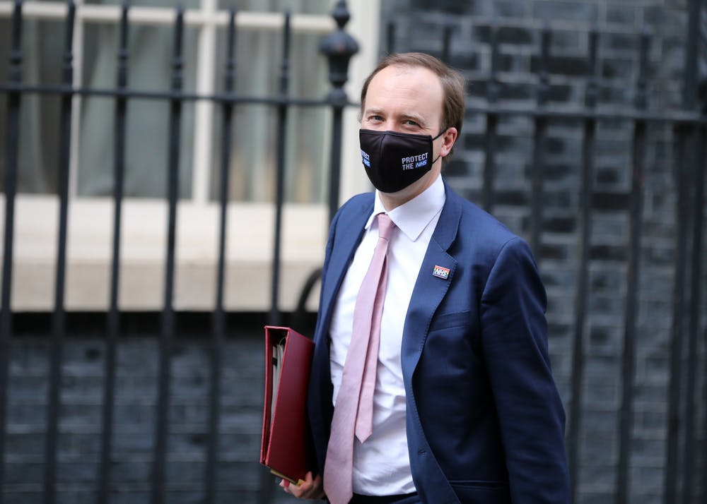 Matt Hancock stands in front of Downing Street wearing a facemask