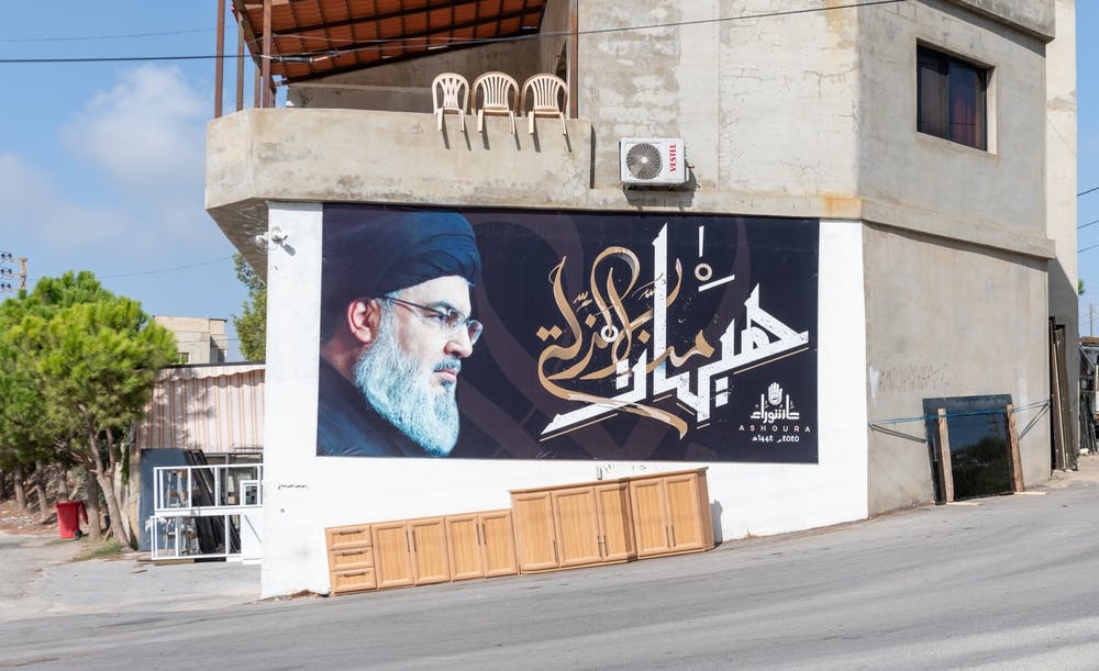 Banner with a photo of Hassan Nasrallah hangs on the side of a building in Lebanon